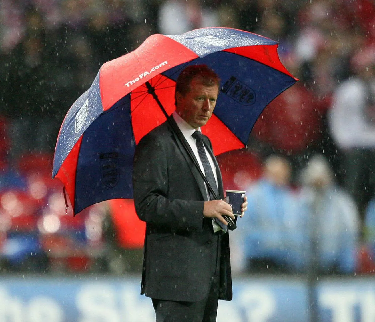 England manager Steve McClaren with a large red and navy striped umbrella against Croatia at Wembley in 2007
