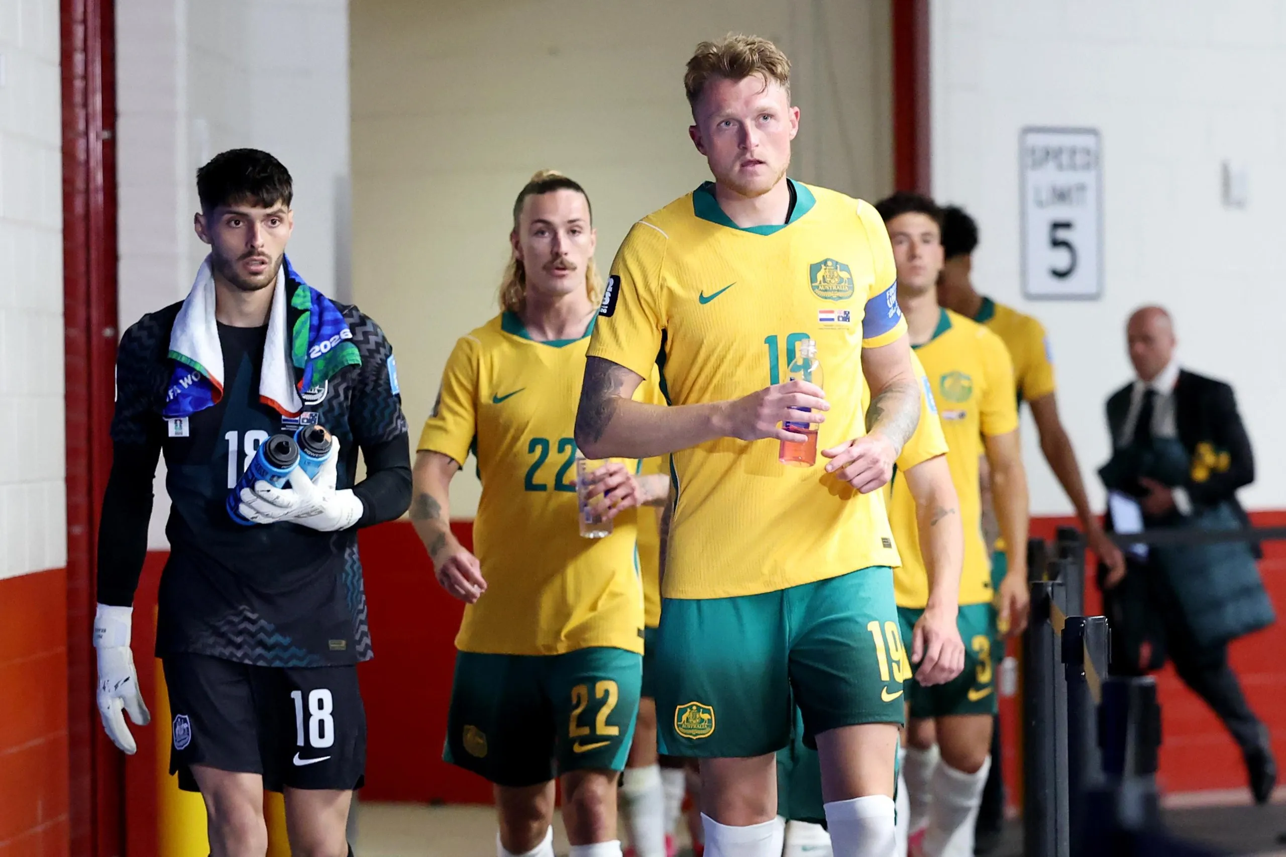 Harry Souttar and Patrick Beach of Australia looks on in the tunnel.