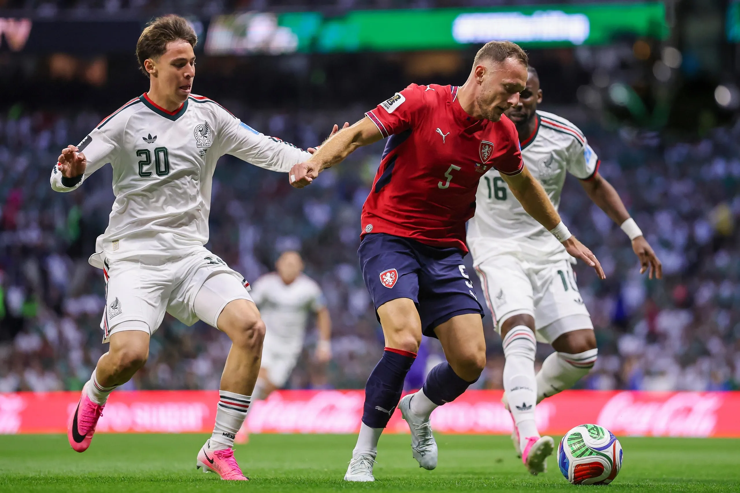 Vladimir Coufal of Czechia controls the ball against Mateo Chavez and Julian Quinones of Mexico.