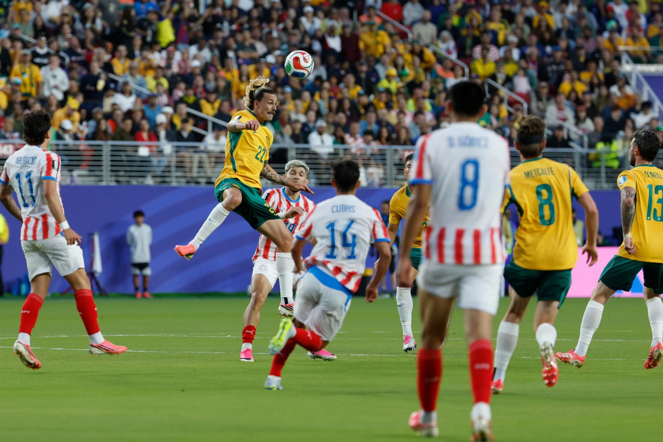Jackson Irvine of Australia heads the ball.