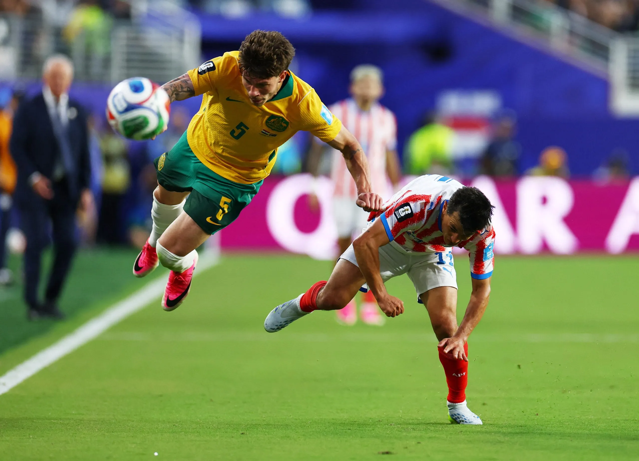 Australia's Jordan Bos in action with Paraguay's Andres Cubas.