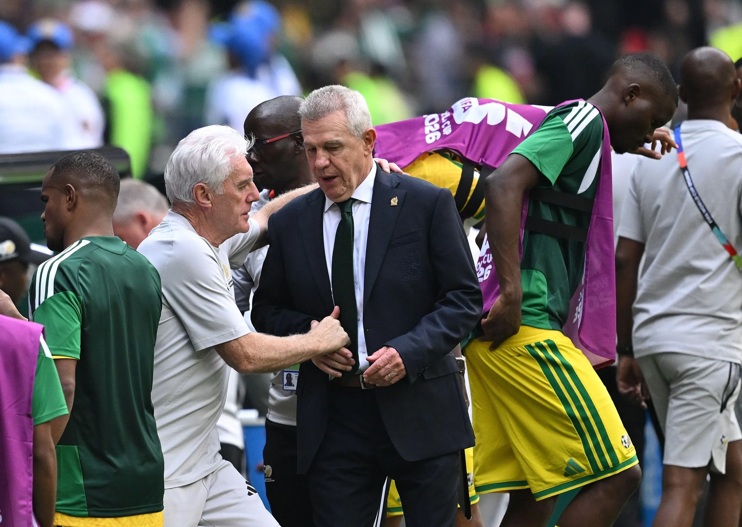 Javeir Aguirre shakes hands with Hugo Broos, head coach of South Africa