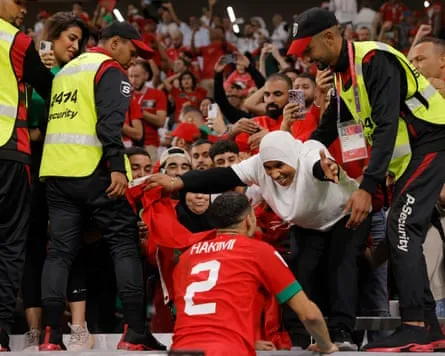 Achraf Hakimi, who scored the winning penalty for Morocco, greets his mother after the match against Spain in Doha, Qatar, 6 December 2022