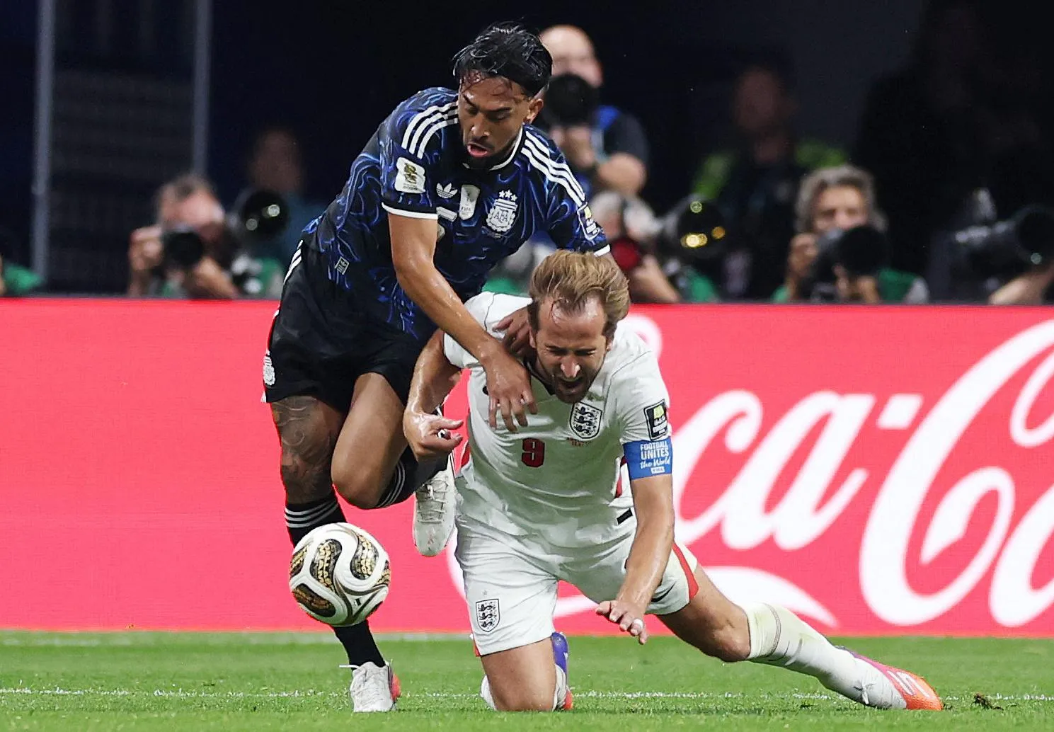 Argentina’s Nico González fouls England’s Harry Kane.