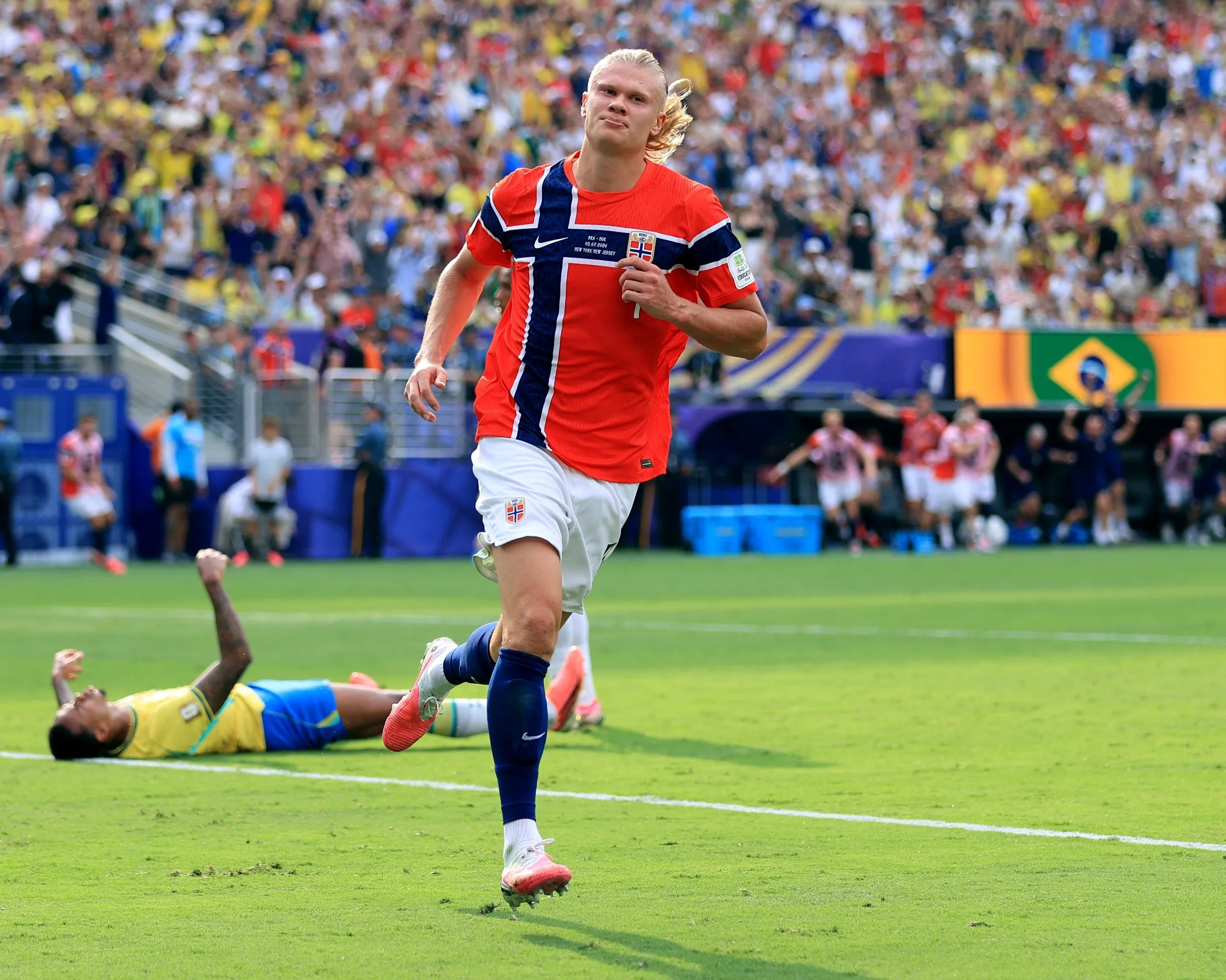The Norway striker Erling Haaland runs away celebrating, leaving the Brazil defender Gabriel on the floor, after scoring in his team’s 2-0 World Cup last 16 win in New York/New Jersey.