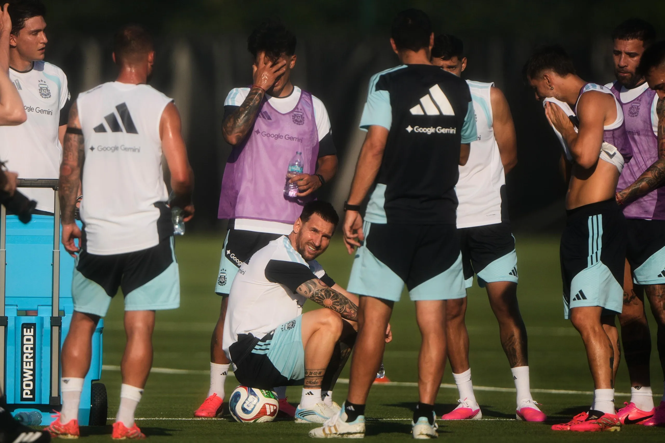 Lionel Messi takes a break with his Argentina teammates during a training session